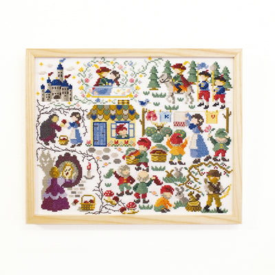 A collection of Olympus 'Nostalgic Story' cross stitch kits featuring classic fairy tale scenes like Snow White displayed with vibrant embroidery threads and 14-count Aida fabric
