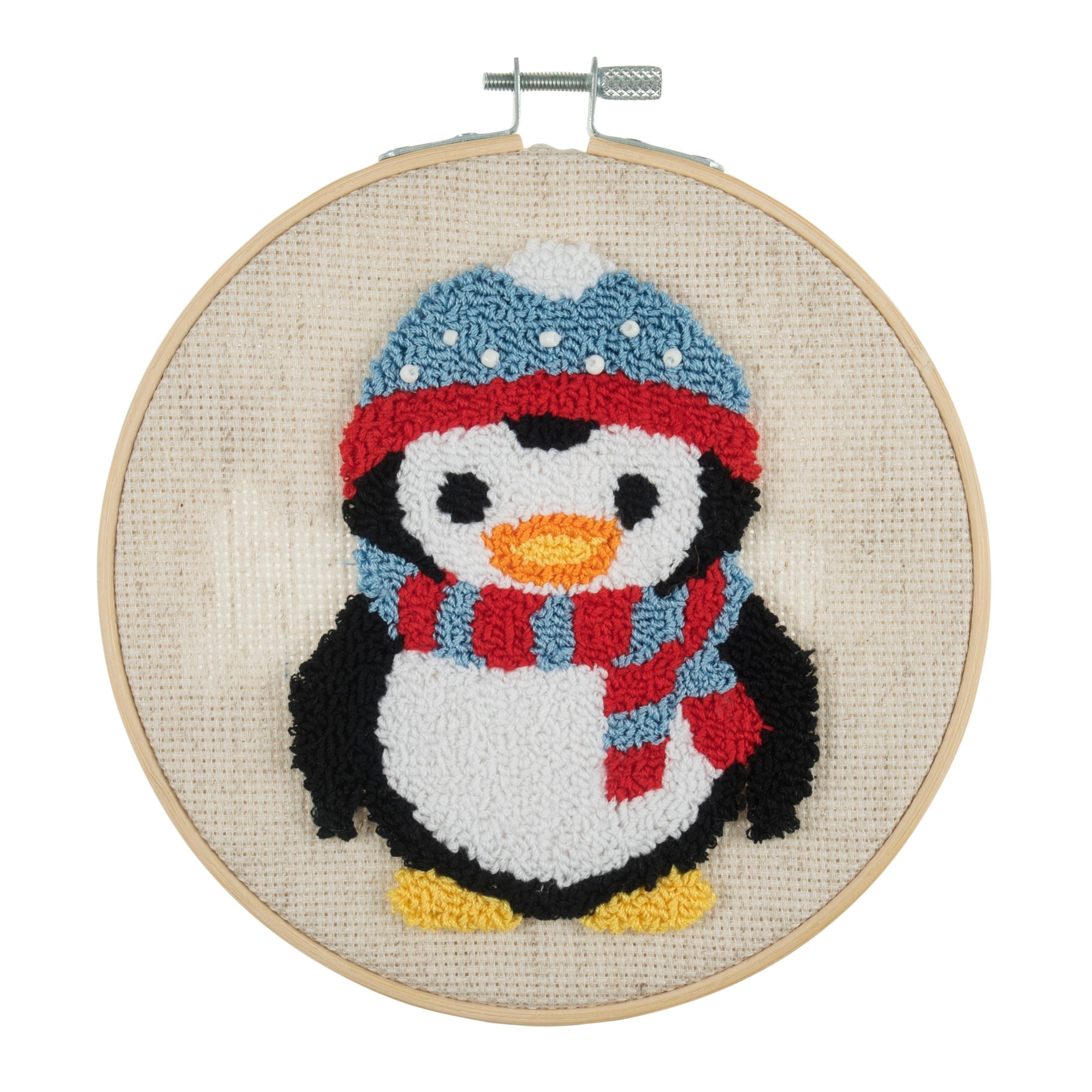 A punch needle hoop with a plastic non-slip hoop, featuring a colorful penguin design with a blue and red hat, yellow shoes, and a scarf.