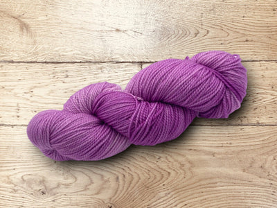 Worsted weight skeins of yarn on a wooden surface. 100% Superwash Merino Wool for sale