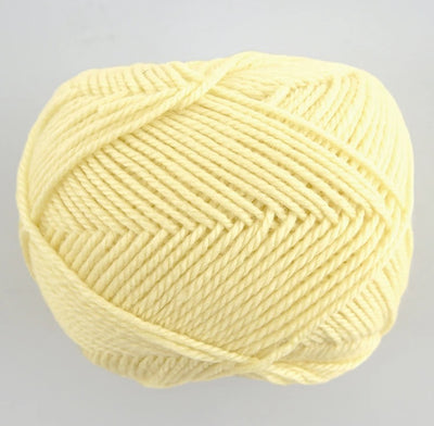 A 30g skein of Pierrot Fine Merino yarn in a soft matte finish, showing the delicate, tightly twisted 100% extra fine merino wool in pale yellow colour.