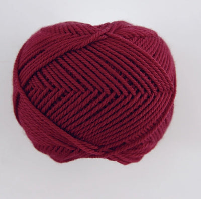 A 30g skein of Pierrot Fine Merino yarn in a soft matte finish, showing the delicate, tightly twisted 100% extra fine merino wool deep red