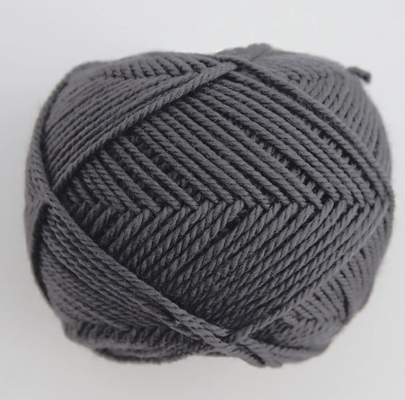 A 30g donut-style ball of Pierrot Fine Merino yarn. The image showcases the smooth, tightly spun plies of 100% Extra Fine Merino wool, reflecting the high-quality Japanese craftsmanship and the soft, matte finish characteristic of premium boutique yarns in slate grey