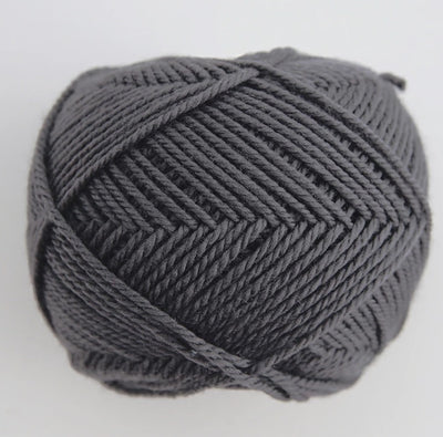 A 30g donut-style ball of Pierrot Fine Merino yarn. The image showcases the smooth, tightly spun plies of 100% Extra Fine Merino wool, reflecting the high-quality Japanese craftsmanship and the soft, matte finish characteristic of premium boutique yarns in slate grey