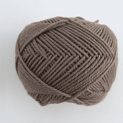 A 30g donut-style ball of Pierrot Fine Merino yarn. The image showcases the smooth, tightly spun plies of 100% Extra Fine Merino wool, reflecting the high-quality Japanese craftsmanship and the soft, matte finish characteristic of premium boutique yarns in cocoa brown colour
