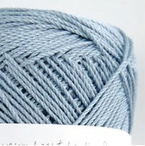 Pure silk fingering yarn, high-drape silk yarn, breathable summer yarn, silk for lace shawls, premium Japanese needlecraft supplies. A luxurious 40g ball of Pierrot Julien 100% Silk yarn in a soft powder blue colour, showcasing its brilliant natural luster