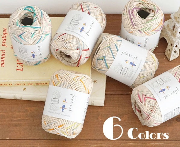 Several skeins of Pierrot Little Fun 100% Cotton Yarn arranged on a surface, displaying a variety of colors and the brand's labeling.
