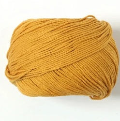 Close-up of Pierrot Orgabits One cotton yarn, showcasing the clean, uniform twist and soft natural fibers of this premium Japanese yarn in mustard gold colour