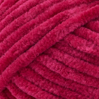 Close-up of Premier Parfait Chunky polyester yarn, highlighting the dense, plush pile and vibrant color in berry red colour