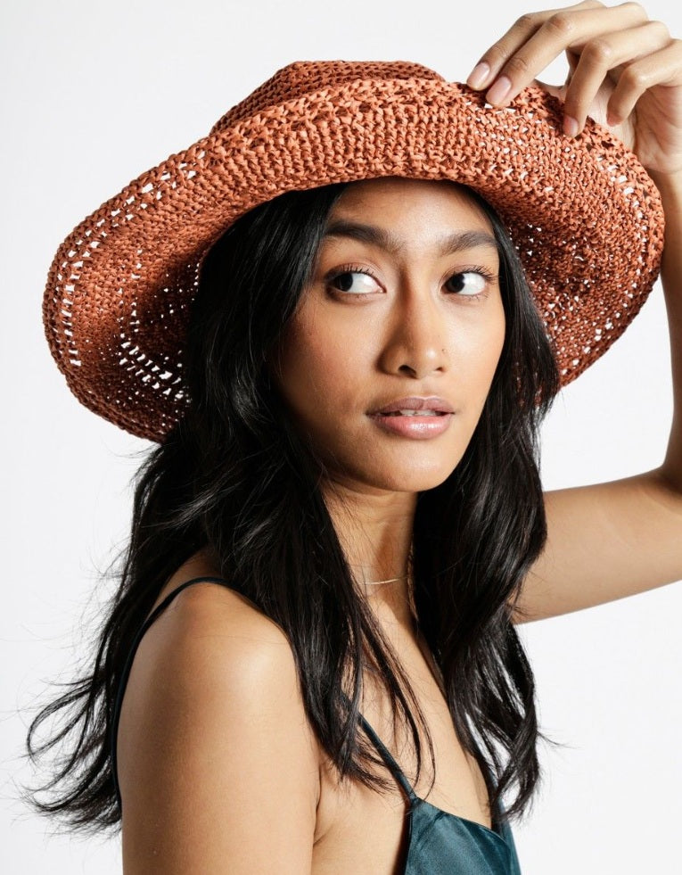 A durable roll of Ra-Ra Raffia yarn, ideal for crocheting structured summer sun hats, beach bags, and airy home decor accessories with a natural, rustic finish.