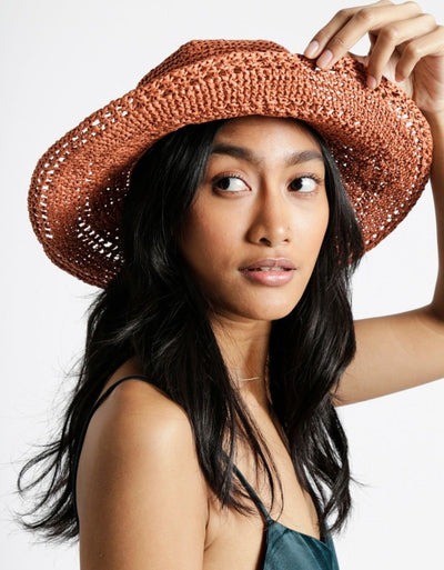 A durable roll of Ra-Ra Raffia yarn, ideal for crocheting structured summer sun hats, beach bags, and airy home decor accessories with a natural, rustic finish.