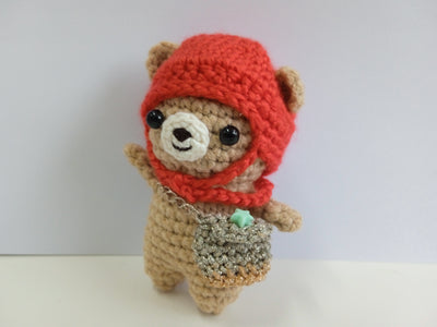 Crocheted mini teddy bear with a red hood and star sling bag on a white background. Artisan Made in Singapore. Crocheted item for Sale
Stuffed animal photography