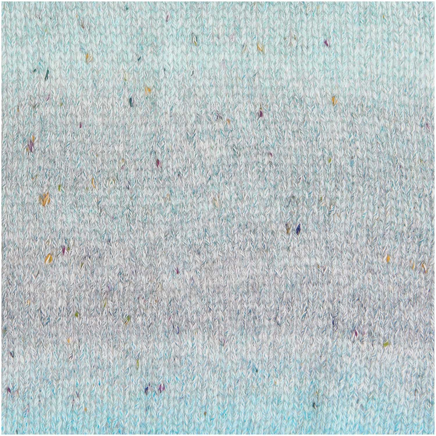 A 50g ball of Rico Fashion Cotton Light & Long Tweed DK yarn, featuring a soft gradient transition from light green to green, accented with delicate multicolored tweed flecks throughout the strand.