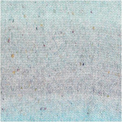 A 50g ball of Rico Fashion Cotton Light & Long Tweed DK yarn, featuring a soft gradient transition from light green to green, accented with delicate multicolored tweed flecks throughout the strand.