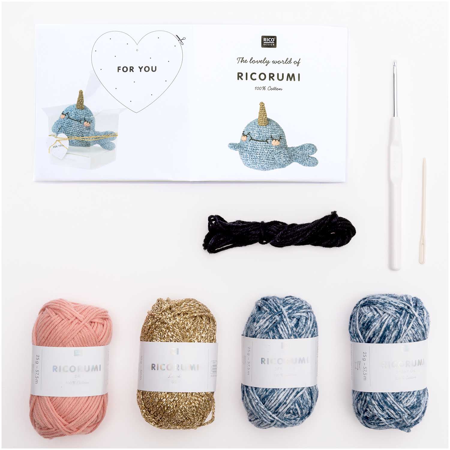 A top-down view of the complete Narwhal kit contents, including shades of blue and metallic gold Ricorumi 100% cotton yarn, a crochet hook, safety eyes, and a needle