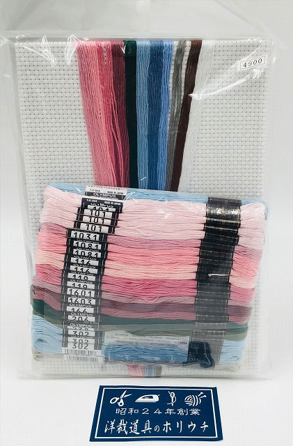 Overhead view of the Olympus kit including the high-quality white Aida, pre-sorted vibrant blue and pink threads, and detailed chart.