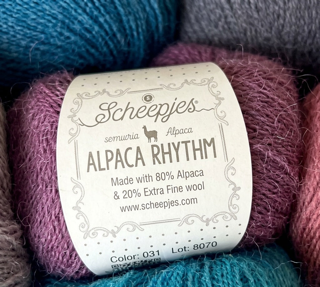 A 25g ball of Scheepjes Alpaca Rhythm yarn, featuring a premium blend of 80% alpaca and 20% extra fine wool in a lace weight for airy knitting and crochet.