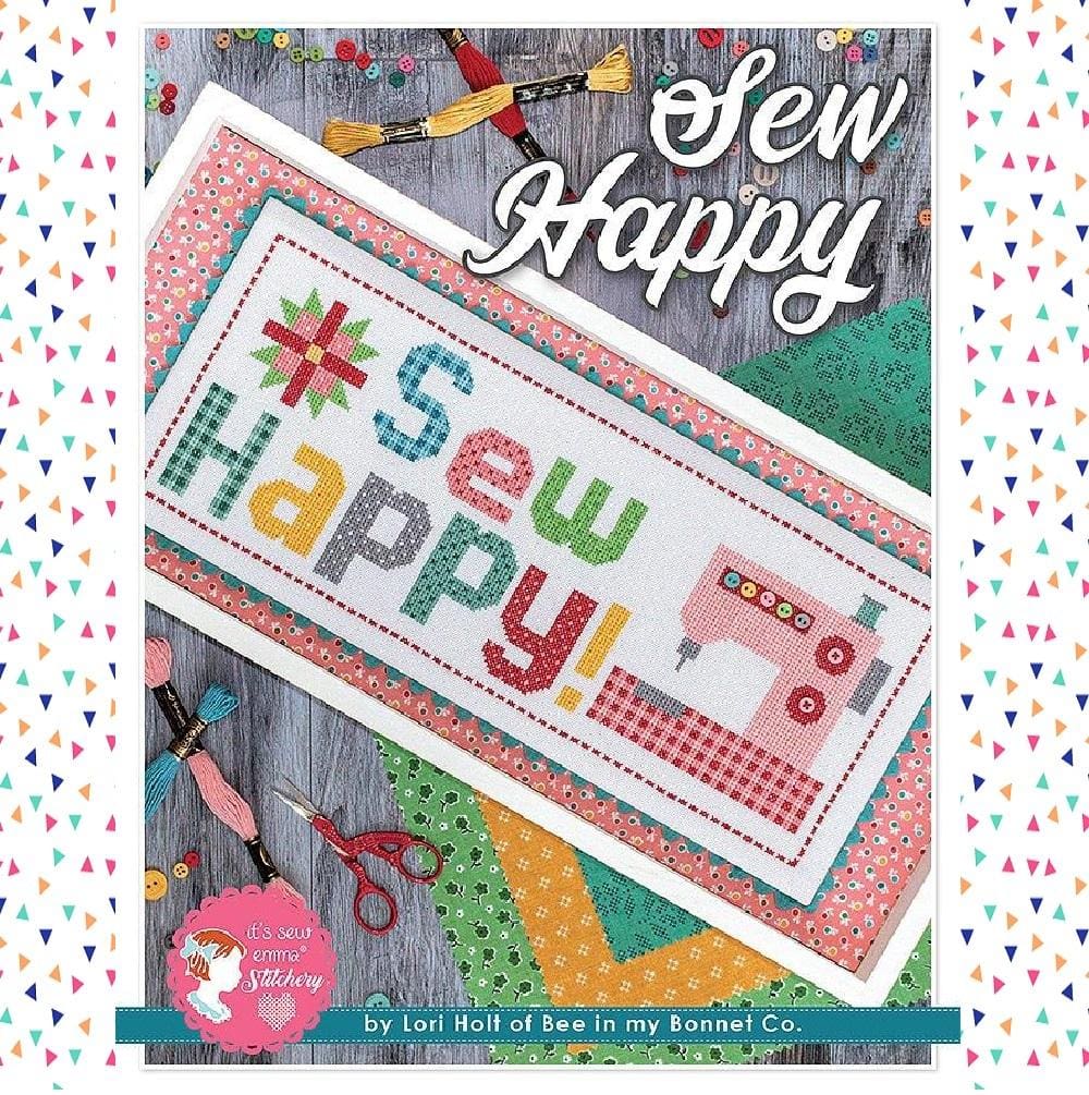 The "Sew Happy" cross stitch kit, showing the complete package with premium embroidery floss, fabric, and a pattern featuring colorful sewing machine and notions motifs.