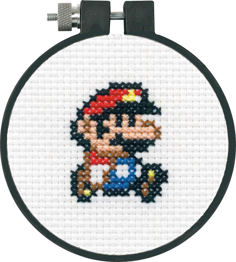 Beginner Cross-stitched character in a hoop on white fabric
