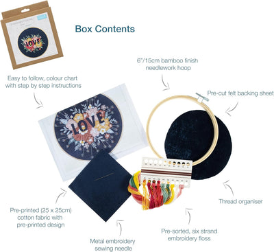 A complete Trimits embroidery kit including a wooden hoop, colorful embroidery floss, needle, and pre-printed fabric with a contemporary 'Love' floral pattern