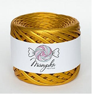 "A roll of Tyanuchka Metallic Yarn in a shimmering silver finish, showing its flat, ribbon-like structure and high-gloss texture in amber gold colour