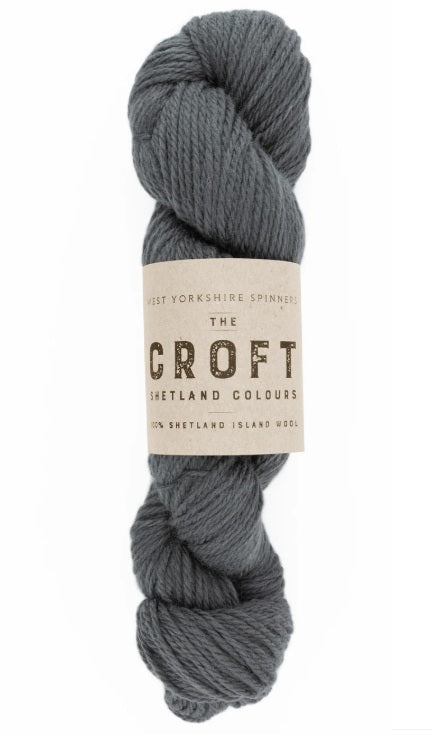 Close-up of WYS The Croft Aran wool in Laxfirth, showing the unique multi-tonal flecks and soft, sturdy handle of authentic Shetland fiber
