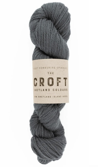 Close-up of WYS The Croft Aran wool in Laxfirth, showing the unique multi-tonal flecks and soft, sturdy handle of authentic Shetland fiber