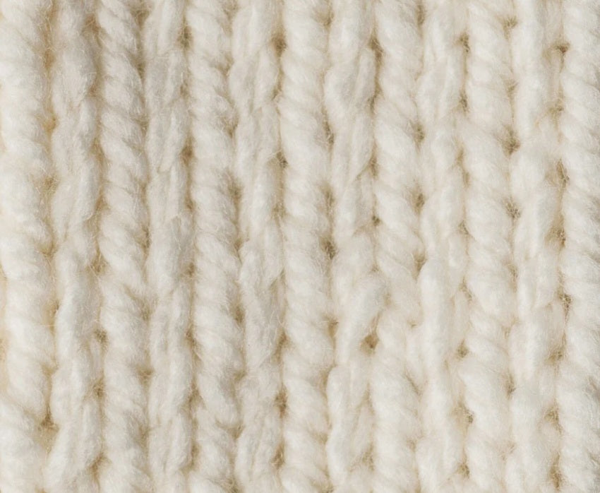 Close-up of beige yarn texture Close-up of the plush, super bulky plies of Bernat Softee Chunky, highlighting the smooth stitch definition and lack of fuzz in natural colour knitting yarn