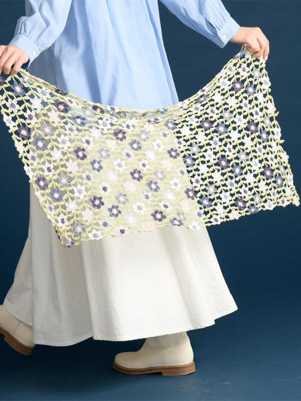 crochet this flora crochet shawl from pattern book. 
A spread showing various vibrant floral crochet motifs and their corresponding symbol diagrams