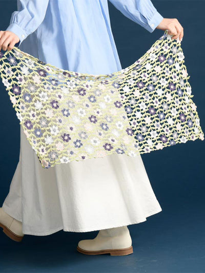 crochet this flora crochet shawl from pattern book. 
A spread showing various vibrant floral crochet motifs and their corresponding symbol diagrams
