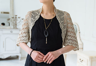 A model wearing a fashionable crochet open layered pullover.