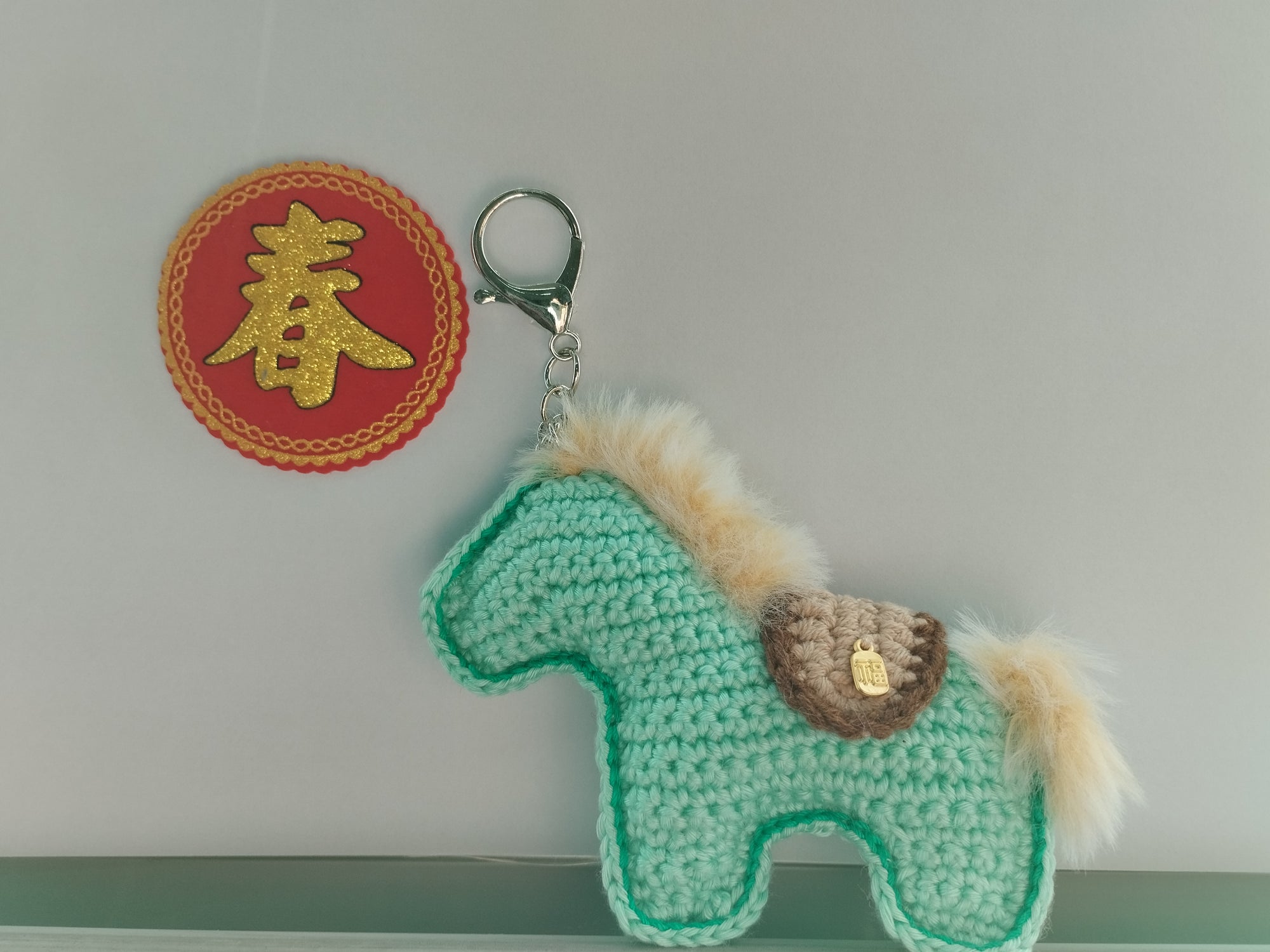 Hand crocheted in Singapore artisan Crochet horse-shaped keychain. Small craft shop hand made item for sale.