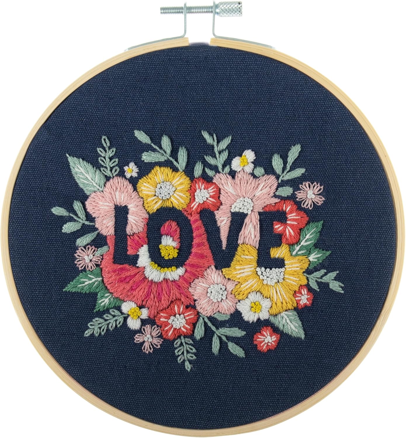 Finished Trimits Love embroidery hoop art displayed on a wooden gallery wall, showcasing a handmade Valentine's or wedding gift idea