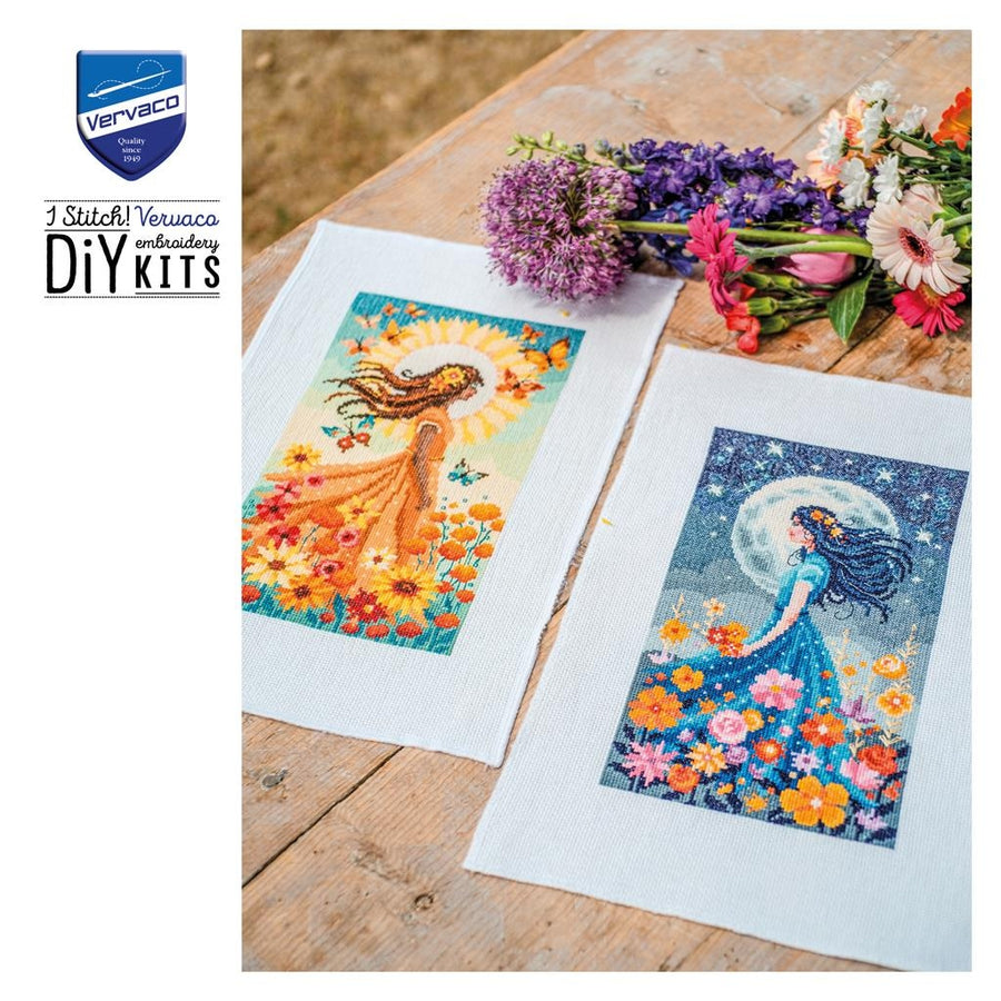 Two cross-stitching designs on fabric with a bouquet of flowers on a wooden surface, featuring Vervaco branding.