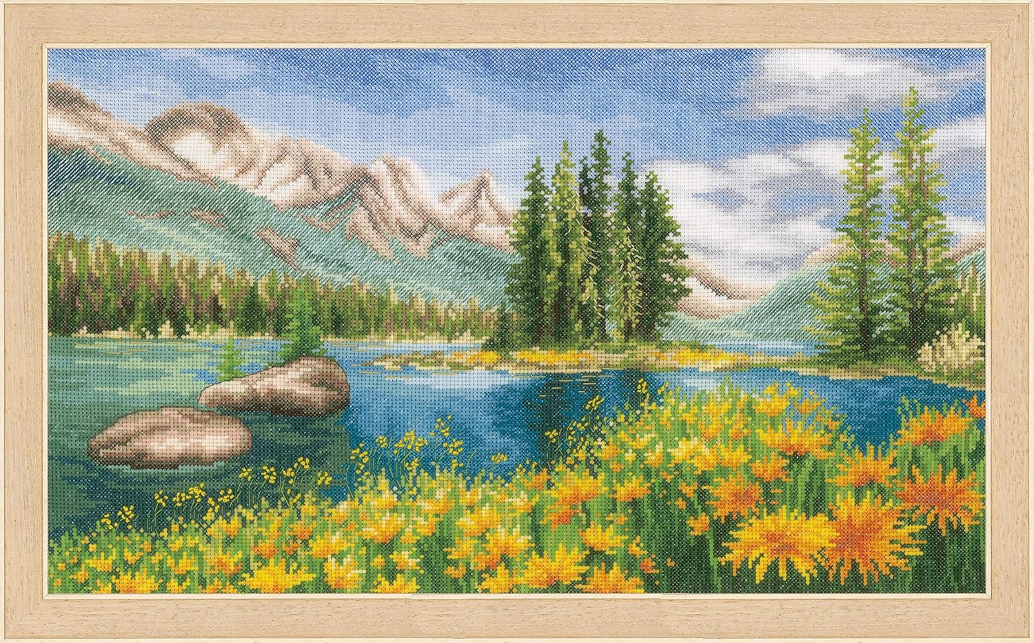 Cross-stitched landscape with mountains, lake, trees, and flowers in a wooden frame. full cross stitch kit