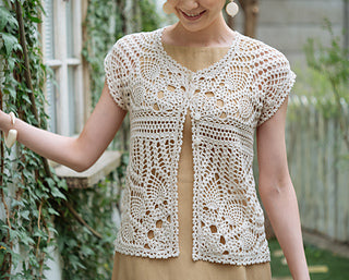 A model wearing a modern, cream colour, lacy opening vest and trendy summer accessories