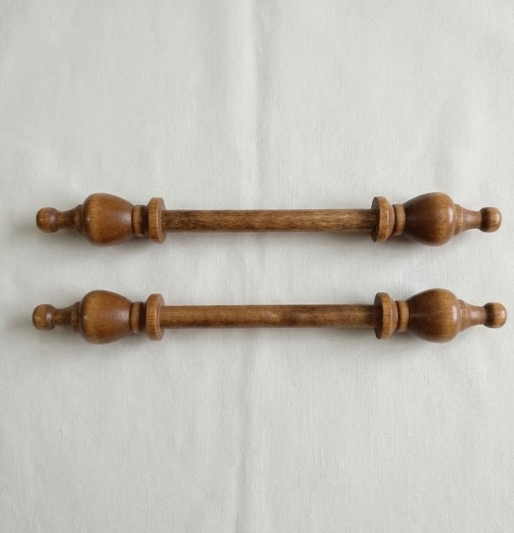 Two wooden drawer pulls on a light Cream background

Close-up of the solid birch end-cap, highlighting the professional craftsmanship and the warm, dark wood grain.