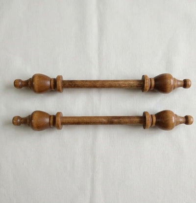Two wooden drawer pulls on a light Cream background

Close-up of the solid birch end-cap, highlighting the professional craftsmanship and the warm, dark wood grain.