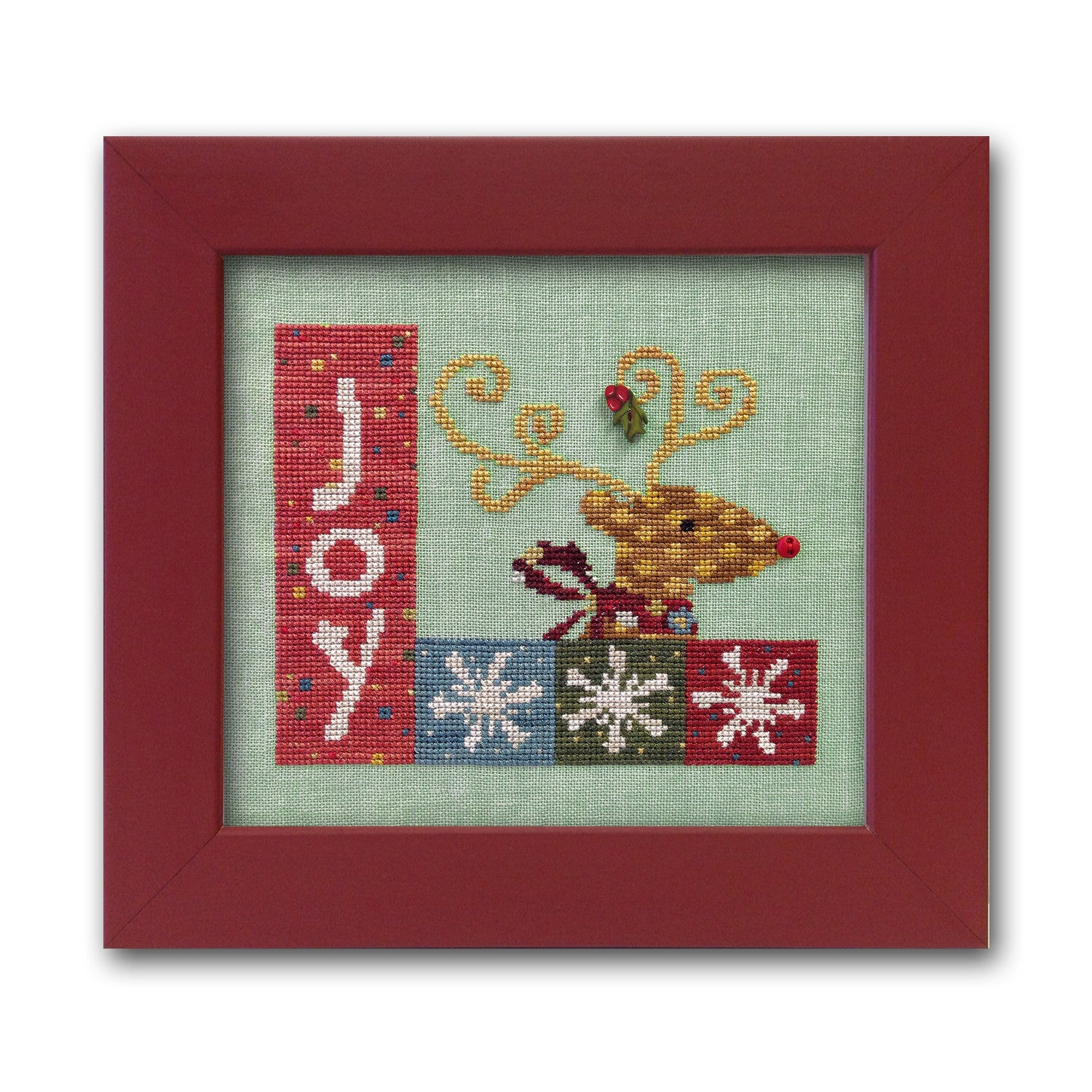 The Art to Heart Christmas Joy cross-stitch chart displayed with its accompanying pack of colorful, handcrafted designer buttons from Just Another Button Company