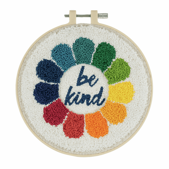 Close-up of the "Be Kind" punch needle design, showcasing the bold, modern typography and the thick, looped yarn texture that creates a soft, 3D effect on the lettering.
