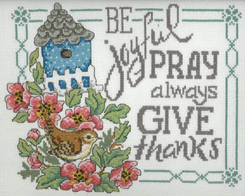 A Diane Arthurs cross-stitch kit featuring the 'Be, Pray, Give' design. The pattern showcases three panels with the words 'Be Joyful,' 'Pray Always,' and 'Give Thanks,' accompanied by delicate seasonal or floral motifs. The kit includes 14-count white Aida fabric, a clear pattern chart, a tapestry needle, and full skeins of authentic DMC embroidery floss.
