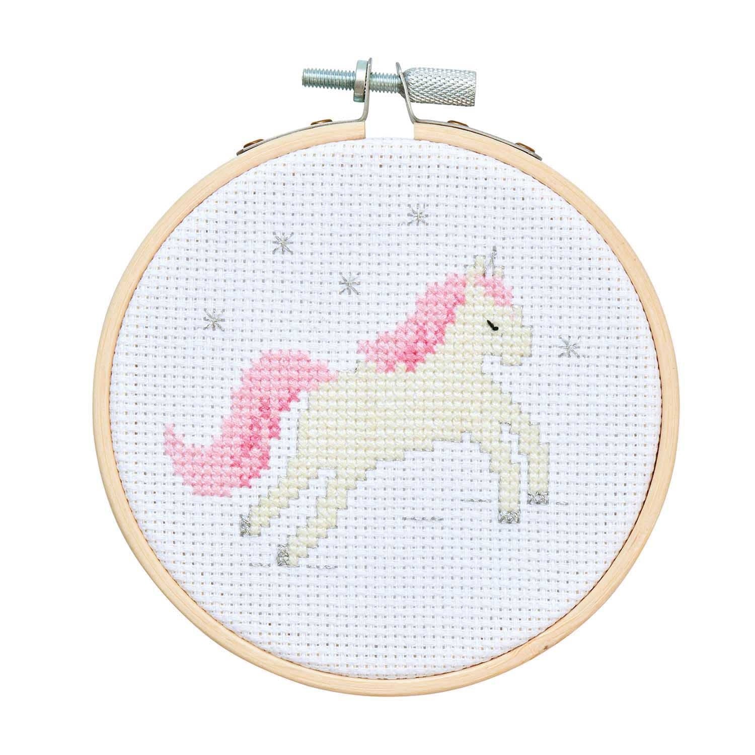 The Rico Unicorn Cross Stitch Starter Kit packaging, showing a colorful finished unicorn design inside a 4-inch wooden embroidery hoop