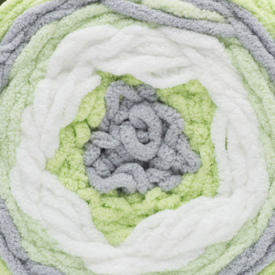 A ball of Bernat Baby Blanket Stripes yarn in green, gray, and white colors.