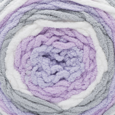 A ball of Bernat Baby Blanket Stripes yarn in Lilac, gray, and white colors.