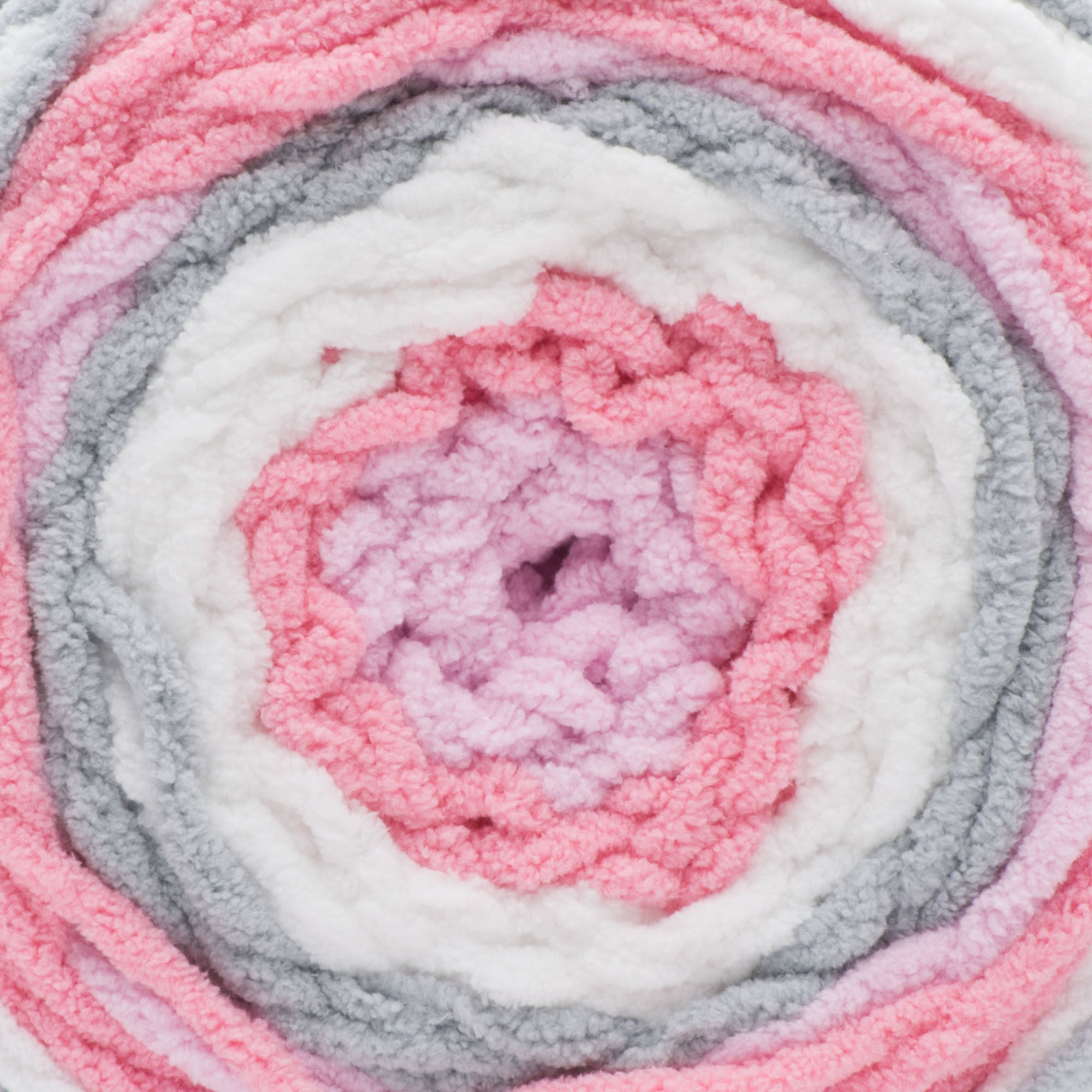 A ball of Bernat Baby Blanket Stripes yarn in pink, gray, and white colors.