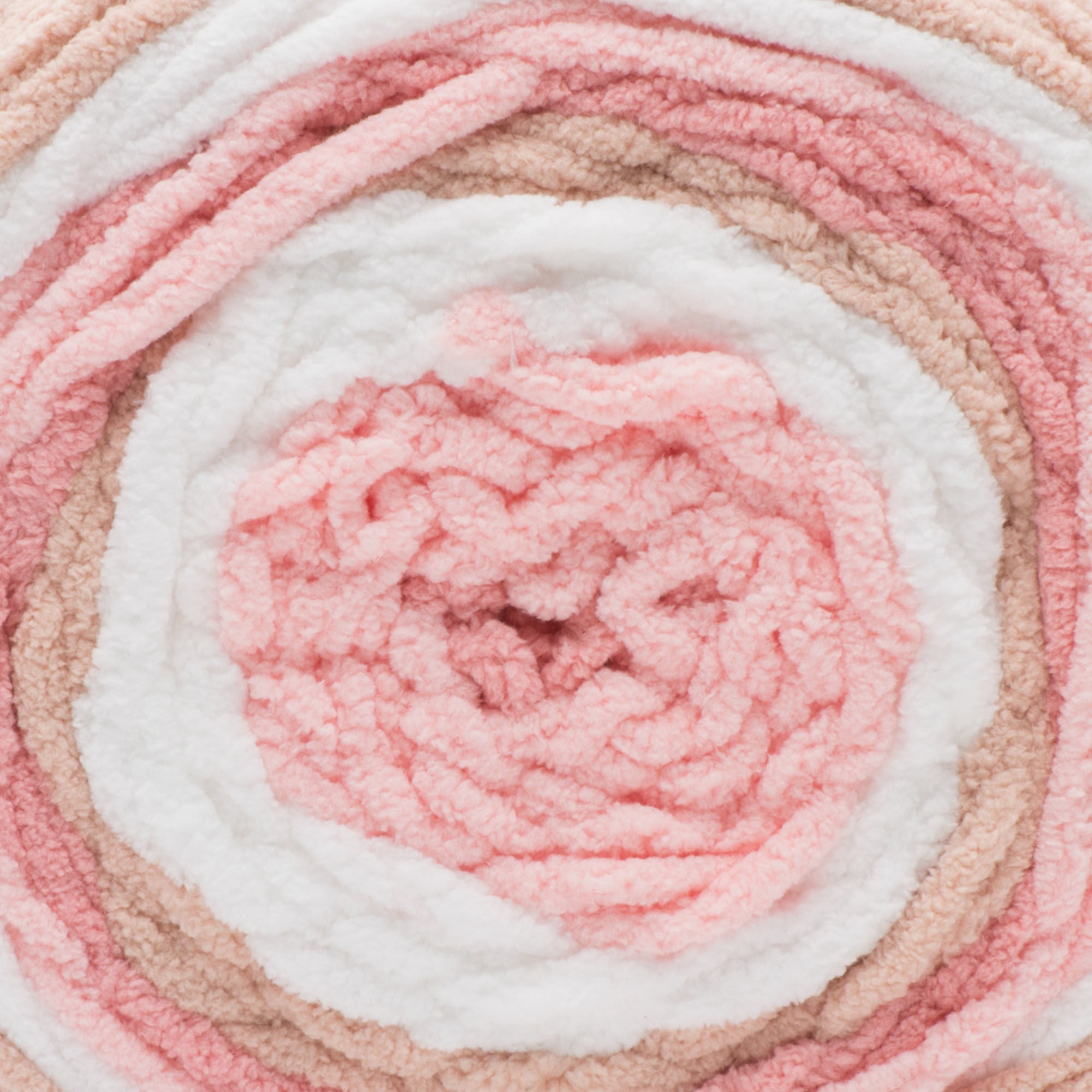 A ball of Bernat Baby Blanket Stripes yarn in coral pink, pink and white colors.