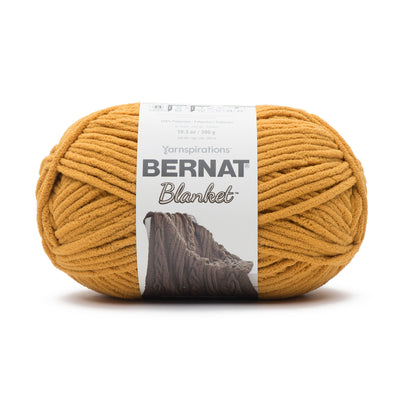 Close-up of Bernat Blanket yarn showing the plush velvety texture; a hypoallergenic and machine-washable yarn ideal for baby blankets and home decor in Nurnt Mustard Colour