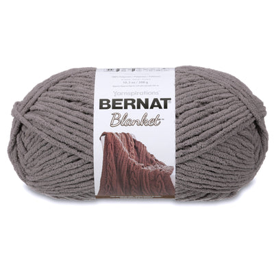 Close-up of Bernat Blanket yarn showing the plush velvety texture; a hypoallergenic and machine-washable yarn ideal for baby blankets and home decor in dark grey colours.