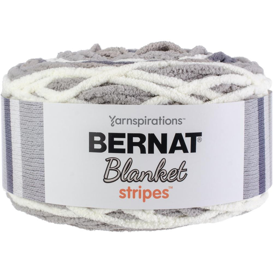 A skein of Bernat Blanket Stripes yarn in gray and white colors.