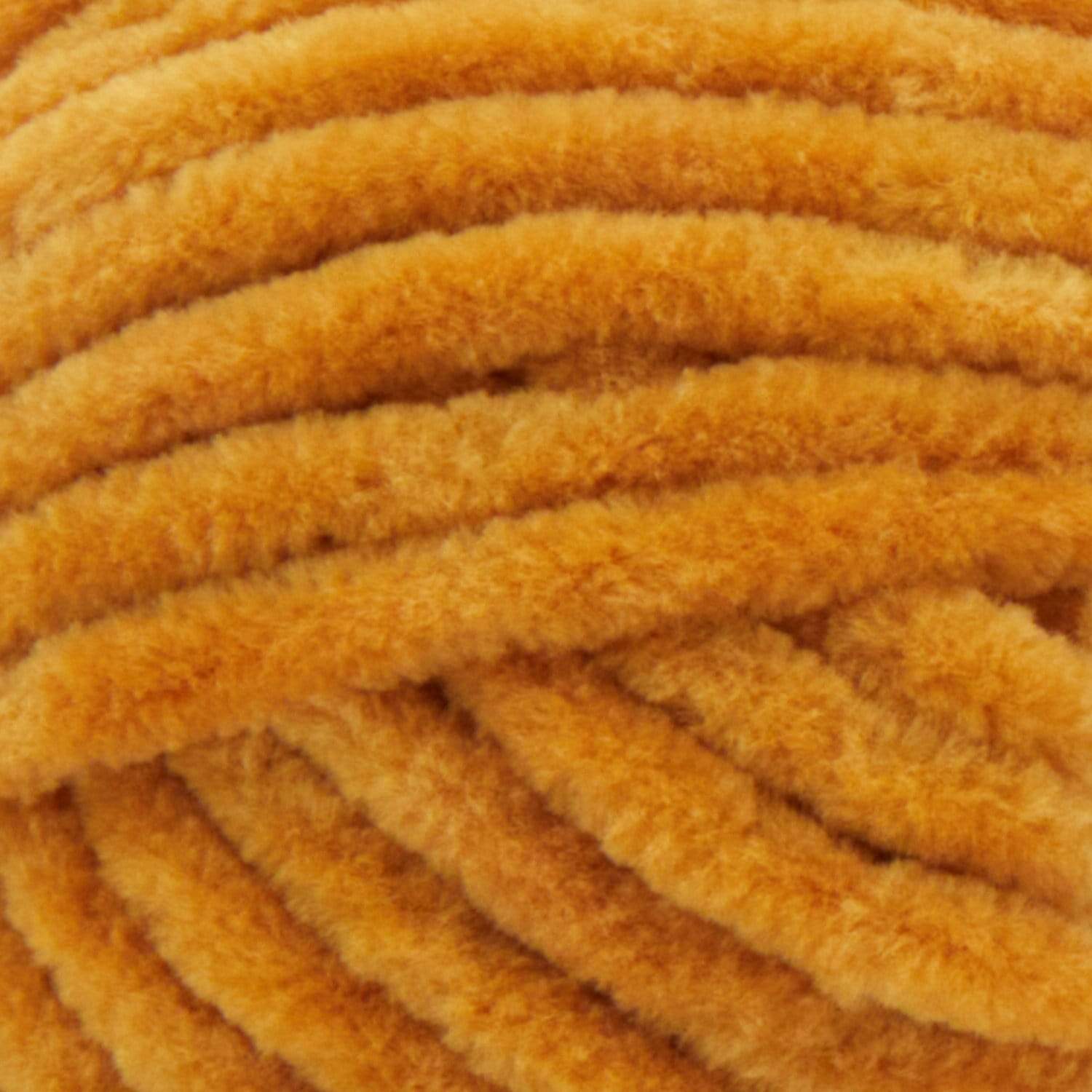A soft, bulky weight Premier Parfait Chunky yarn perfect for making amigurumi and plush home decor in mustard brown