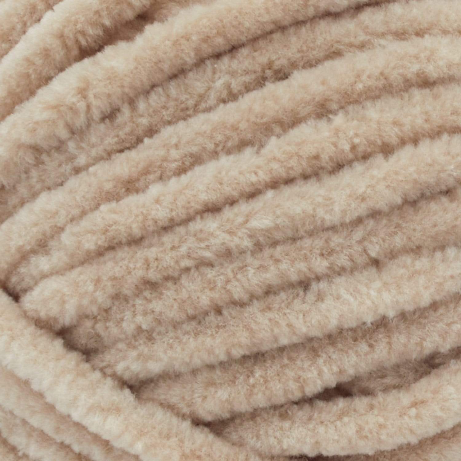 Close-up of Premier Parfait Chunky polyester yarn, highlighting the dense, plush pile and vibrant color in Toffee brown colou
